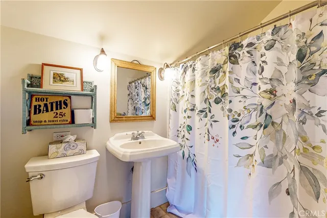 a bathroom with a toilet and a mirror