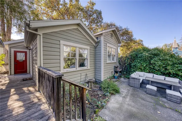 a view of a backyard with table and chairs and potted plants