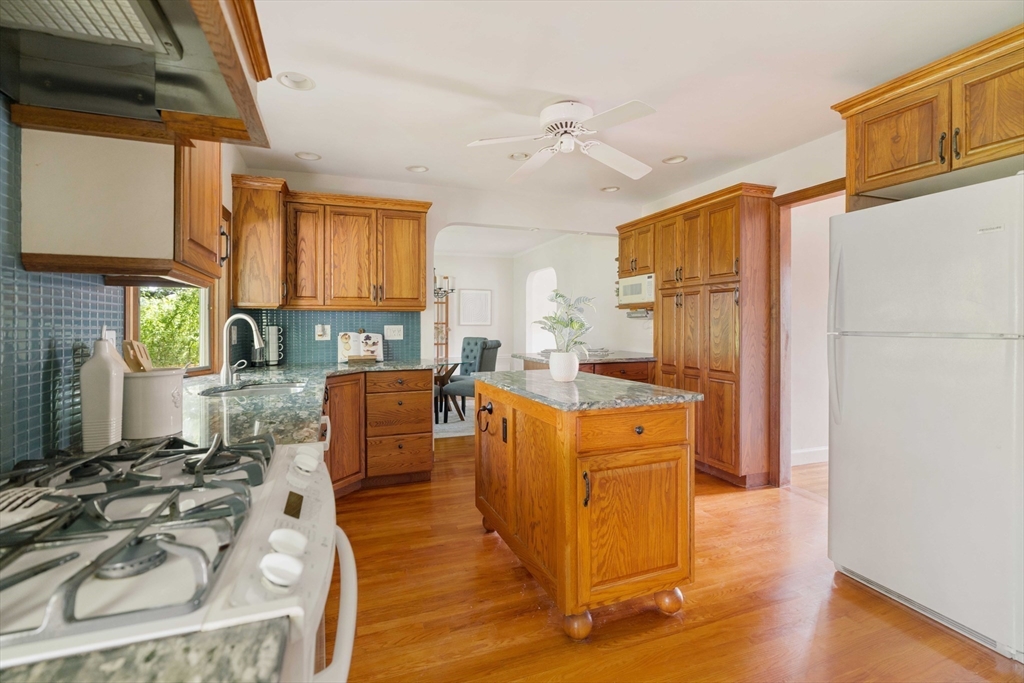 52 St Mary's Road Milton, MA 02186 - Photo 12 of 32 a kitchen with stainless steel appliances a stove a sink dishwasher and a refrigerator with wooden floor