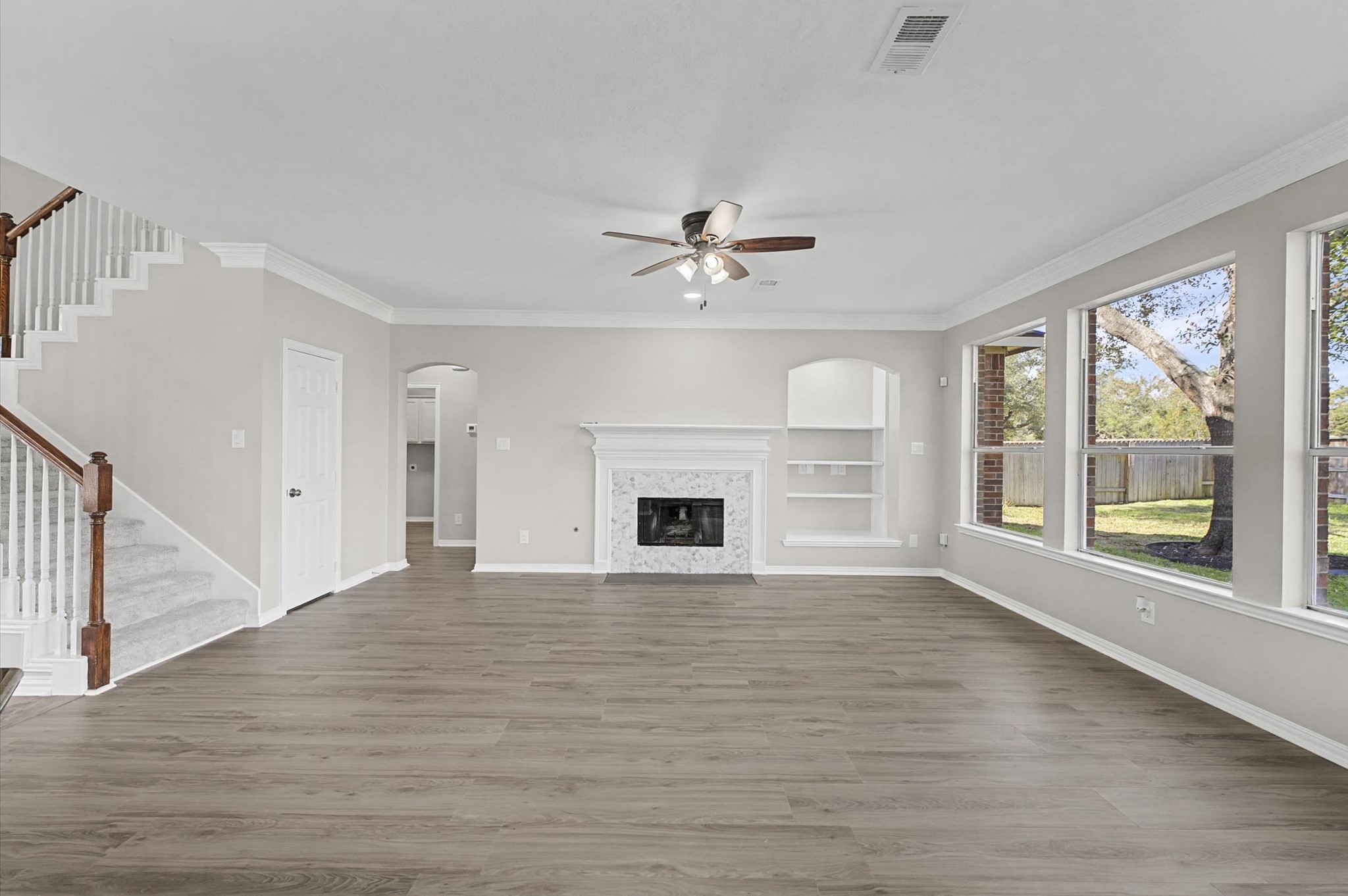 15442 Bay Tree Landing Cypress, TX 77429 - Photo 19 of 46 Wall of windows, tall ceilings, crown molding, built-in shelves and a redesigned fireplace.