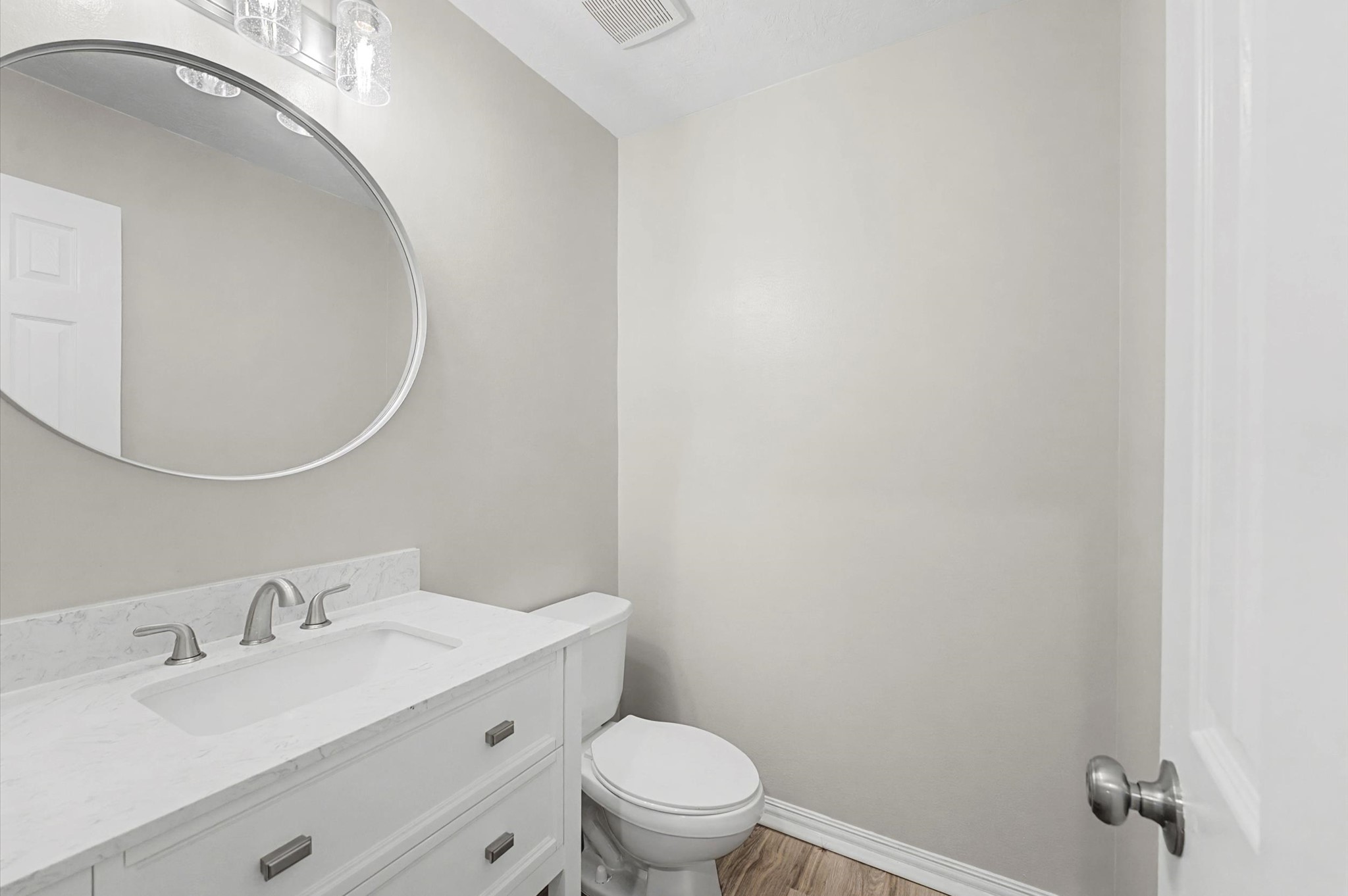 15442 Bay Tree Landing Cypress, TX 77429 - Photo 20 of 46 Half bath downstairs by Primary bedroom. Open slatted shelf below the two pull out drawers offers additional storage for bath essentials.