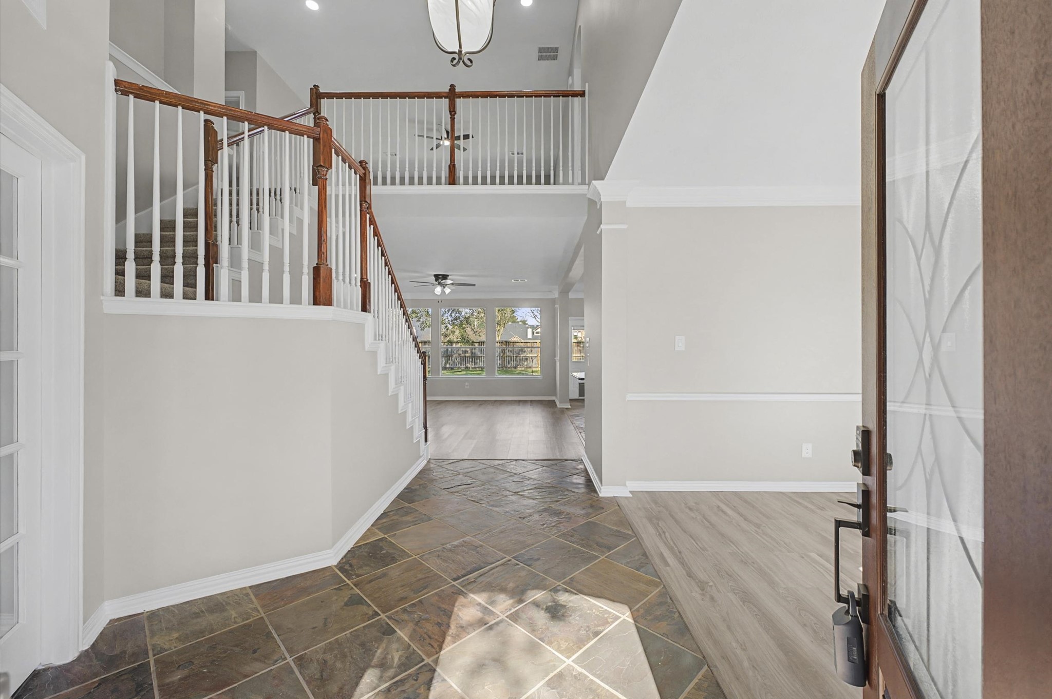 15442 Bay Tree Landing Cypress, TX 77429 - Photo 4 of 46 Beautiful grand entry with 15-foot ceilings, slate tile in the foyer, new lighting, paint and touches throughout.