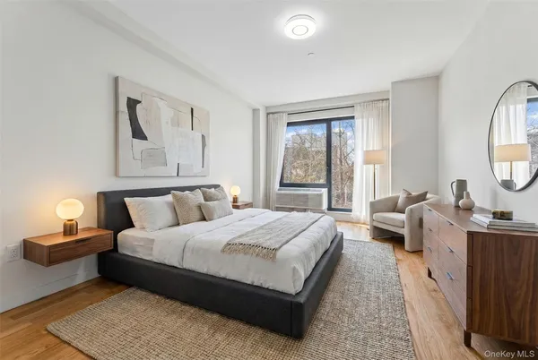 a bedroom with a large bed and a window