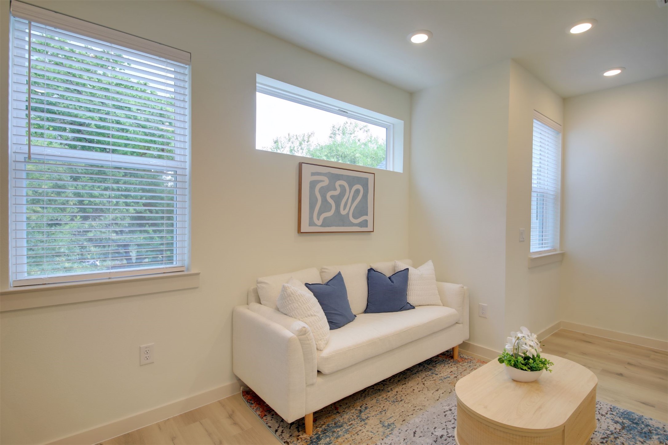 6802 Montana Street, Unit 2 Austin, TX 78741 - Photo 7 of 13 Recessed lighting and ample natural illumination create a bright and inviting sitting area.