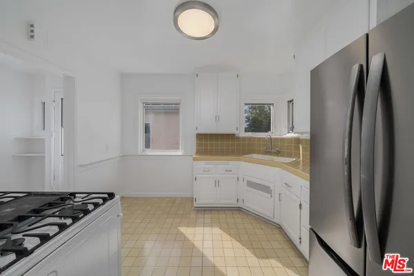 a kitchen with a stove and a refrigerator