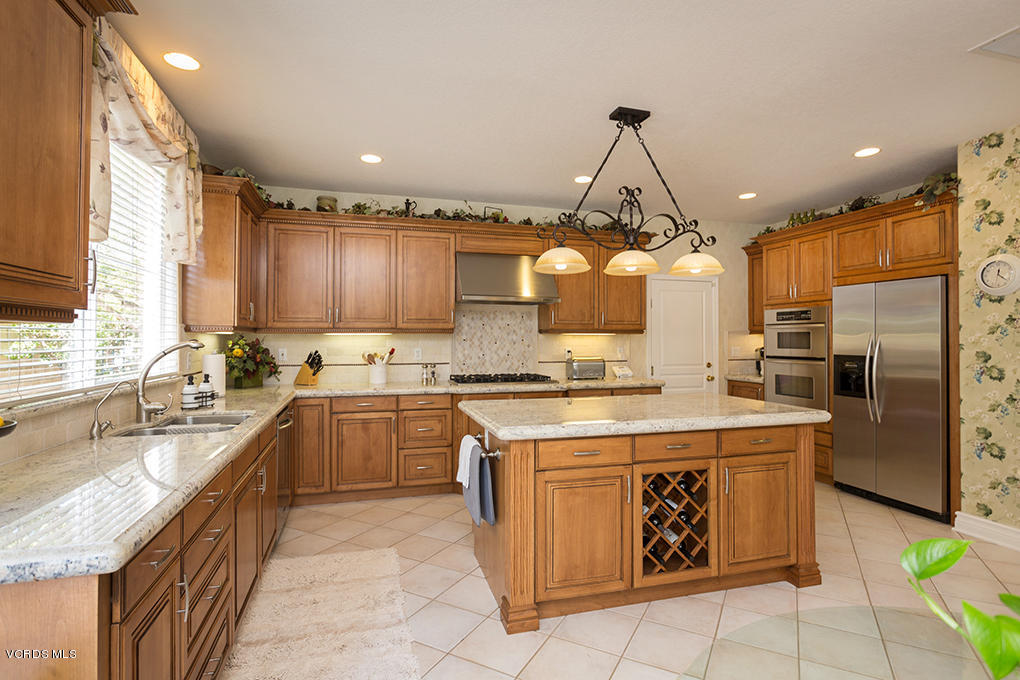 210 Knoll Ridge Road Simi Valley, CA 93065 - Photo 13 of 46 a kitchen with kitchen island granite countertop a sink a counter top space appliances and cabinets