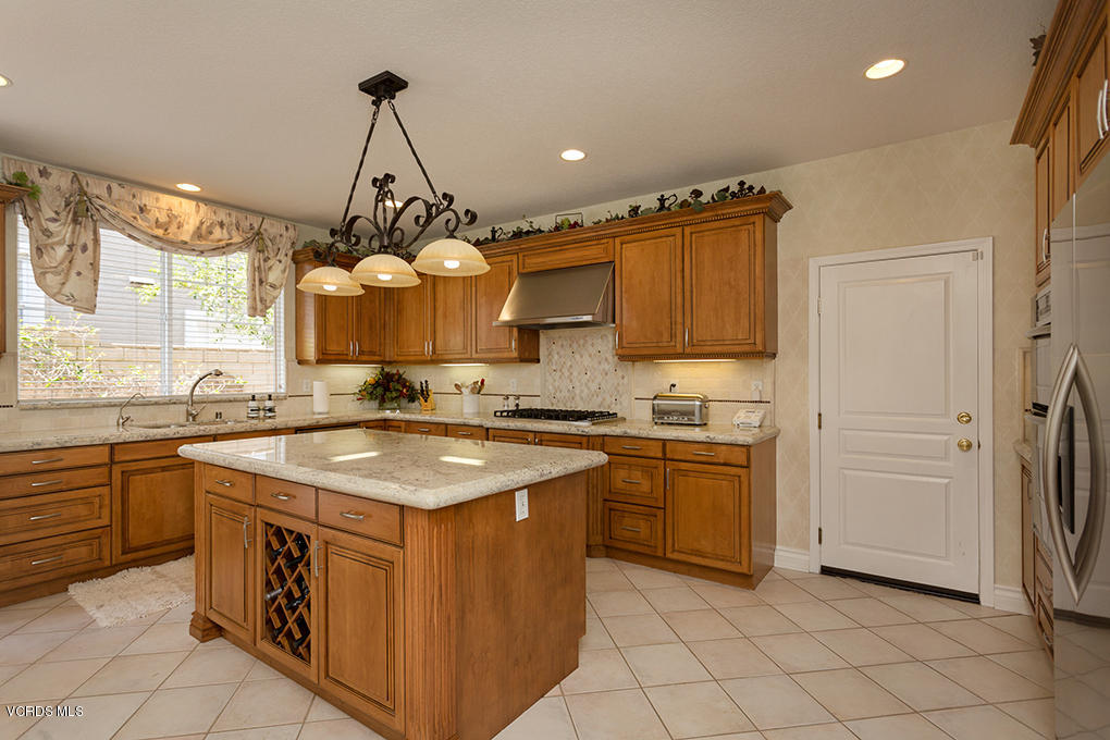 210 Knoll Ridge Road Simi Valley, CA 93065 - Photo 15 of 46 a kitchen with a sink stove and cabinets