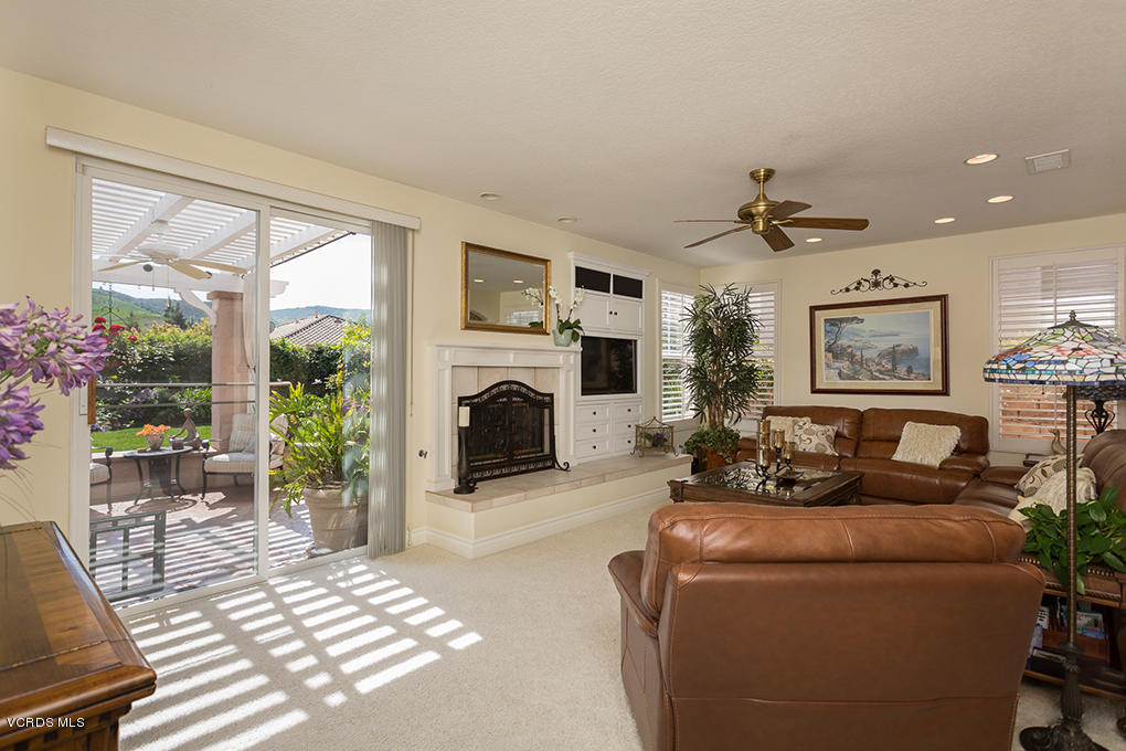 210 Knoll Ridge Road Simi Valley, CA 93065 - Photo 19 of 46 a living room with furniture a large window and a fireplace