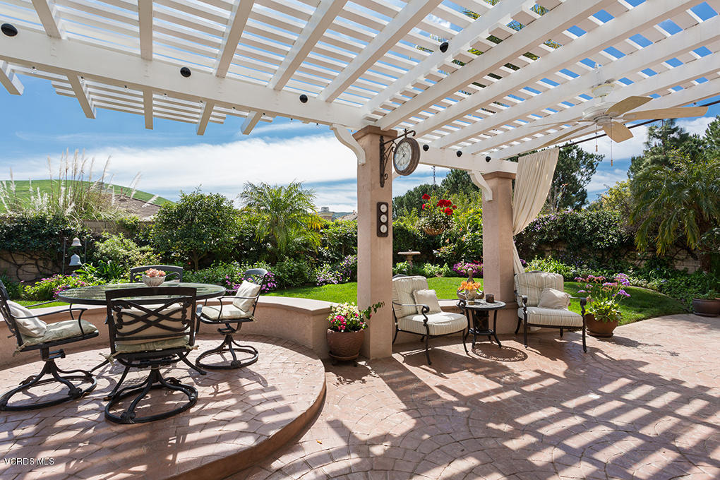 210 Knoll Ridge Road Simi Valley, CA 93065 - Photo 20 of 46 a view of a patio with table and chairs potted plants and large tree