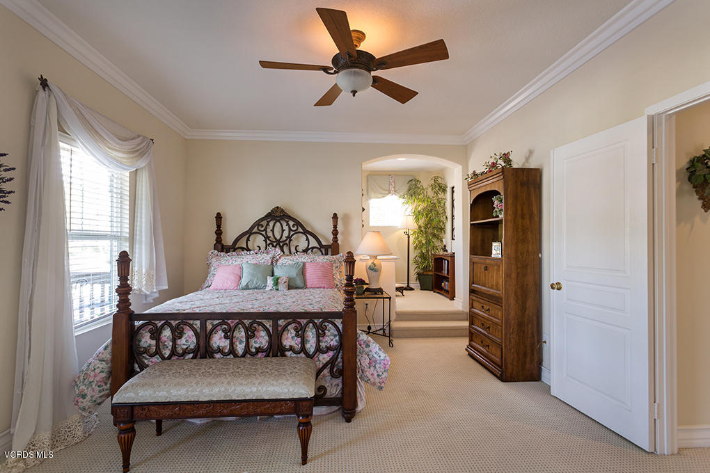 210 Knoll Ridge Road Simi Valley, CA 93065 - Photo 34 of 46 a bedroom with a bed and a chandelier