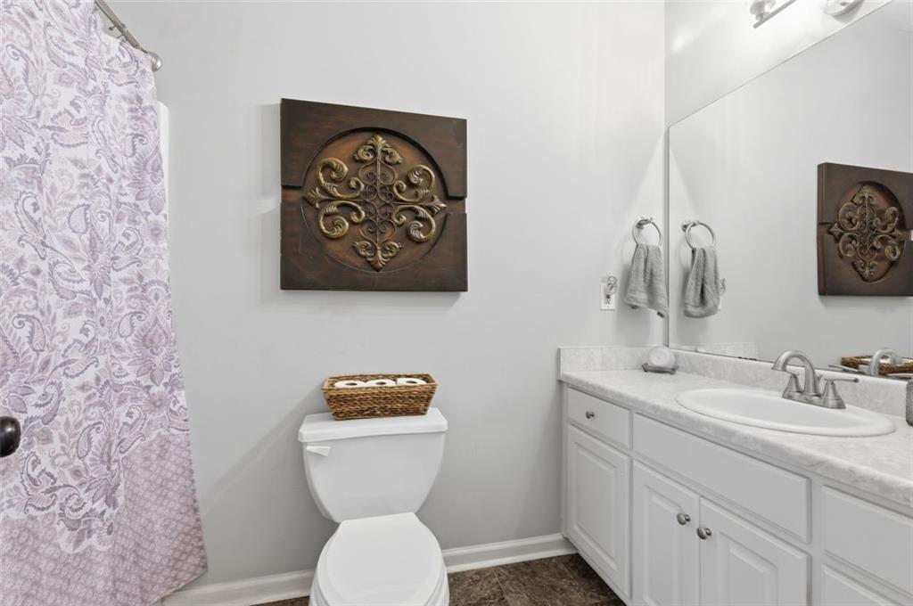 1856 Whitley Road Bethlehem, GA 30620 - Photo 16 of 28 a bathroom with a toilet sink and mirror