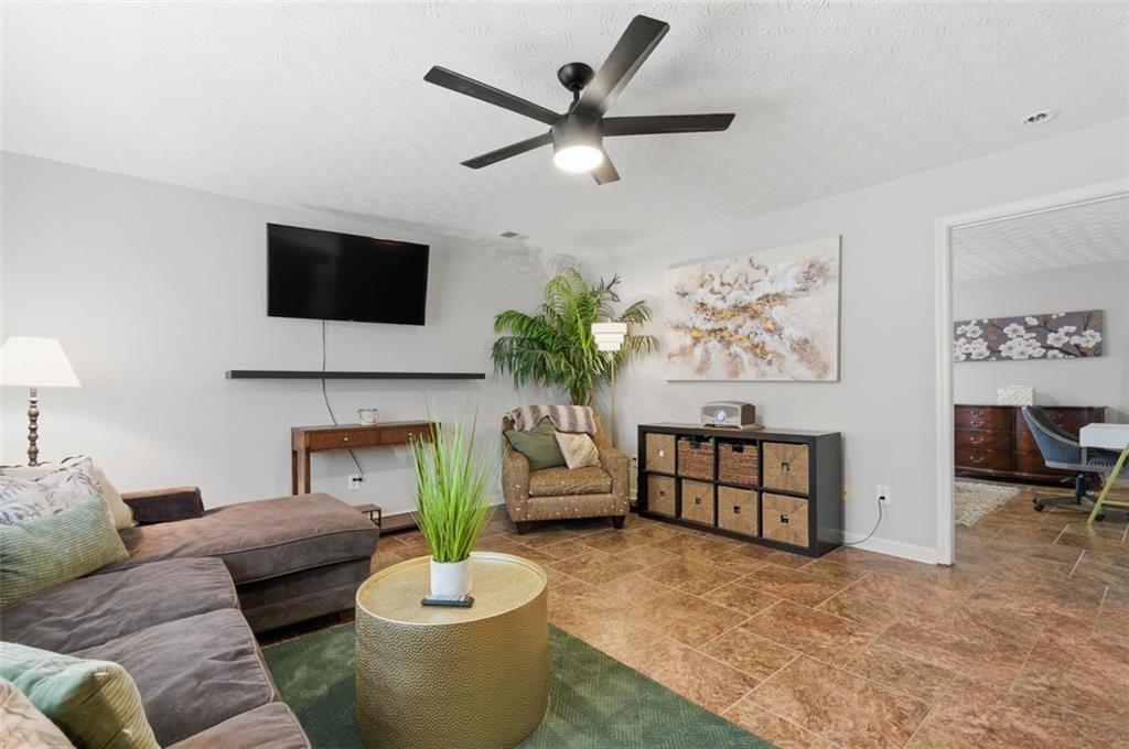 1856 Whitley Road Bethlehem, GA 30620 - Photo 18 of 28 a living room with furniture a flat screen tv and a fireplace