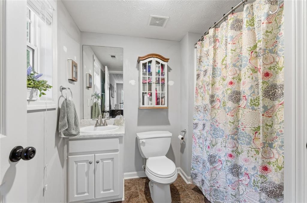 1856 Whitley Road Bethlehem, GA 30620 - Photo 20 of 28 a white toilet sitting next to a shower curtain