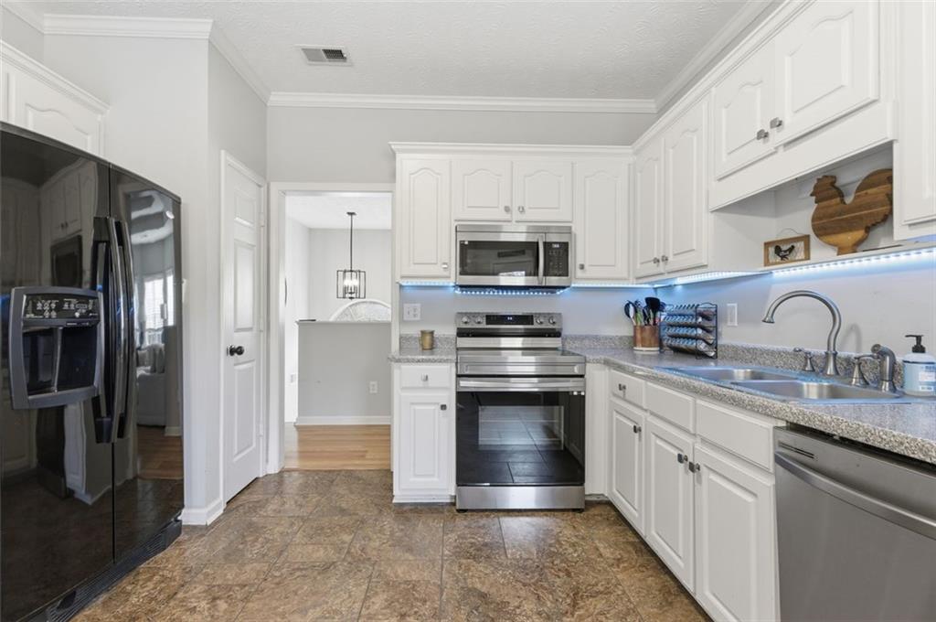 1856 Whitley Road Bethlehem, GA 30620 - Photo 4 of 28 a kitchen with stainless steel appliances granite countertop a refrigerator sink and stove