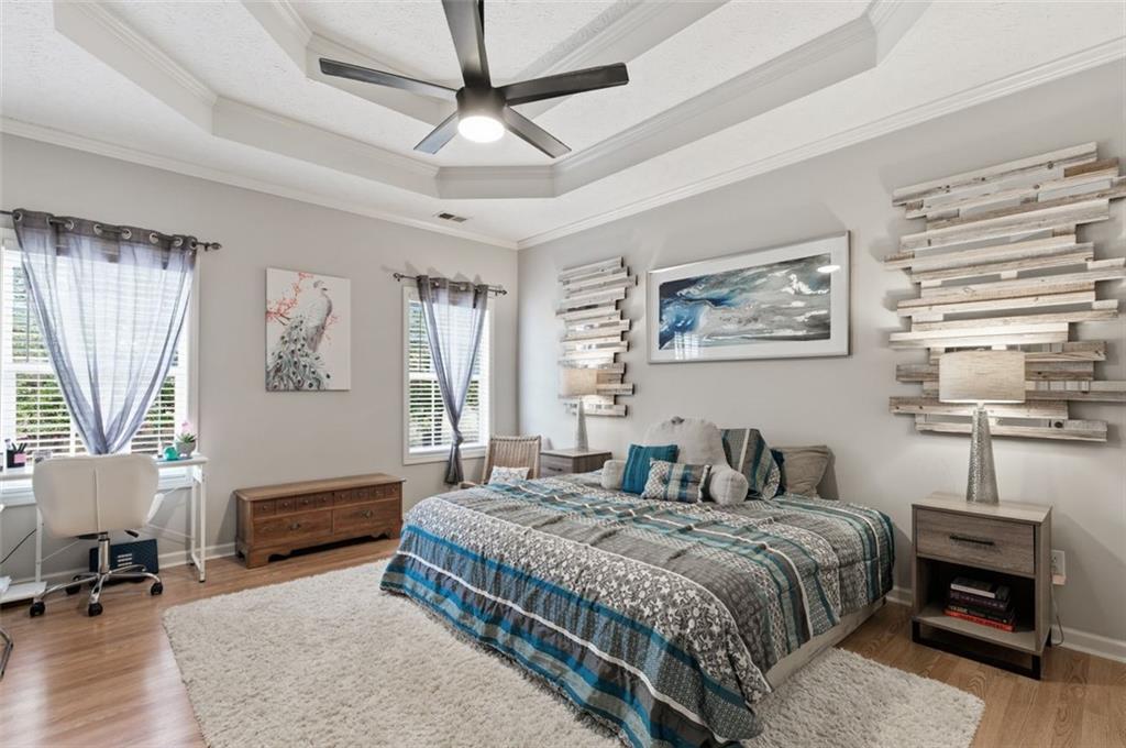 1856 Whitley Road Bethlehem, GA 30620 - Photo 10 of 28 a bedroom with a large bed a chandelier and a window