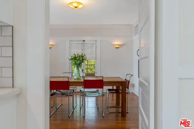 a view of a dining room with furniture and wooden floor