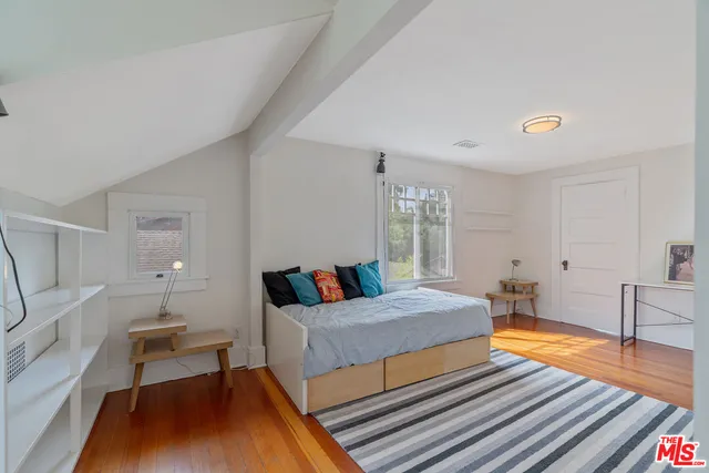 a bedroom with a bed and a table