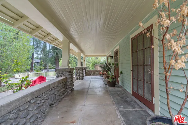 a view of a chairs and table in backyard of the house
