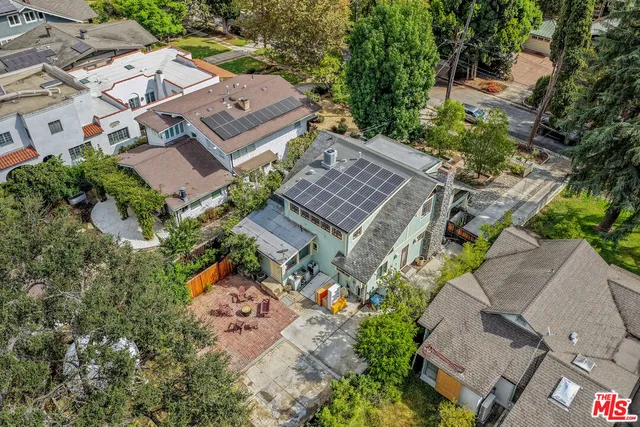 an aerial view of a house with a yard