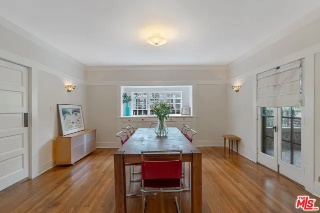 a dining room with furniture and wooden floor
