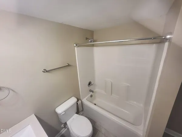 a bathroom with a toilet and a tub