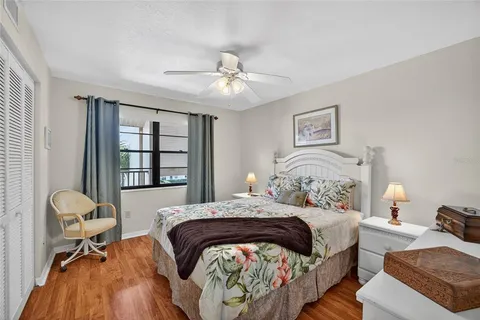 a bedroom with a bed furniture a chandelier and a window