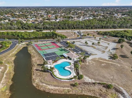 an aerial view of a house with a yard basket ball court and outdoor seating