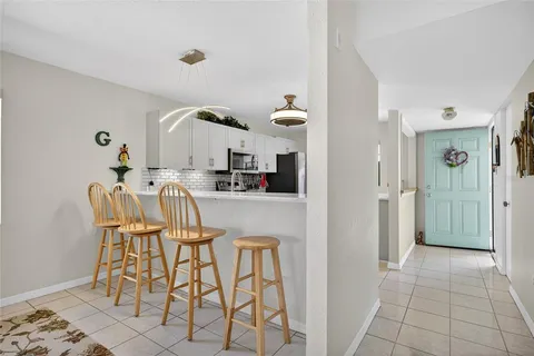 a kitchen with granite countertop a table and chairs