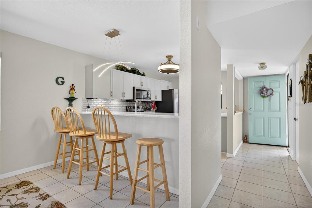 175 Kings Highway, Unit 738 Punta Gorda, FL 33983 - Photo 4 of 36 a kitchen with granite countertop a table and chairs