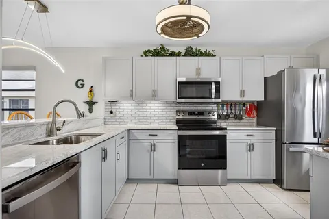 a kitchen with a sink appliances and cabinets