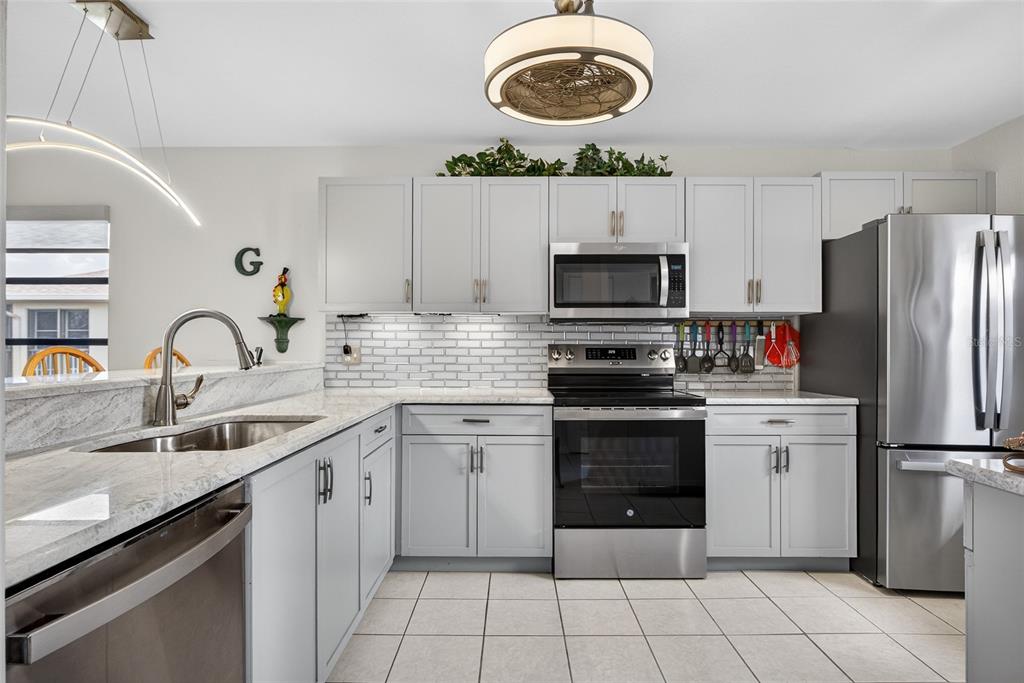 175 Kings Highway, Unit 738 Punta Gorda, FL 33983 - Photo 5 of 36 a kitchen with a sink appliances and cabinets