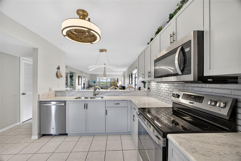 175 Kings Highway, Unit 738 Punta Gorda, FL 33983 - Photo 6 of 36 a kitchen with a stove and a sink