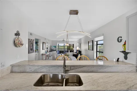 a kitchen with a sink and a chandelier