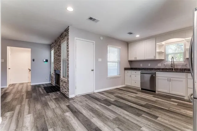 a kitchen with granite countertop a stove and cabinets