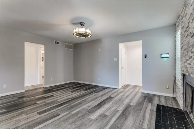 a view of a room with wooden floor