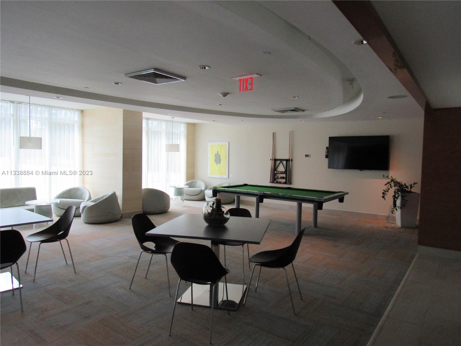 Plaza on Brickell Miami, FL 33131 - Photo 21 of 31 a living room with furniture and a flat screen tv
