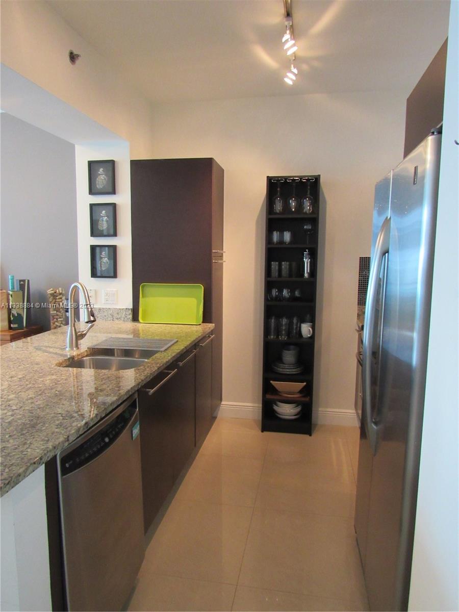 Plaza on Brickell Miami, FL 33131 - Photo 6 of 31 a kitchen with stainless steel appliances granite countertop a refrigerator and a sink