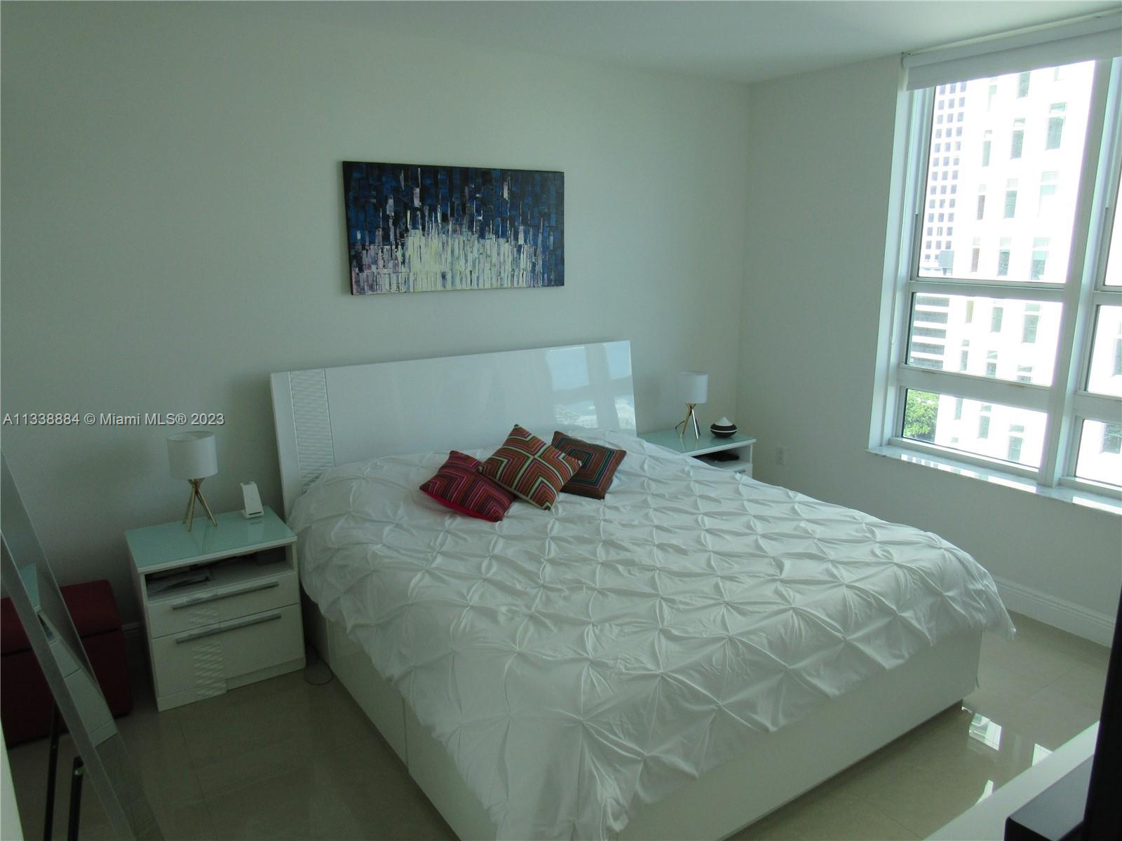 Plaza on Brickell Miami, FL 33131 - Photo 8 of 31 a large bed sitting in a bedroom next to a window