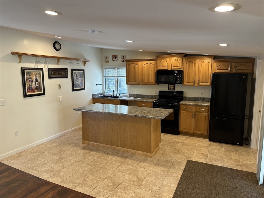 4 Highland Avenue Harvard, MA 01451 - Photo 12 of 29 a kitchen with stainless steel appliances granite countertop a refrigerator a stove top oven a sink and dishwasher