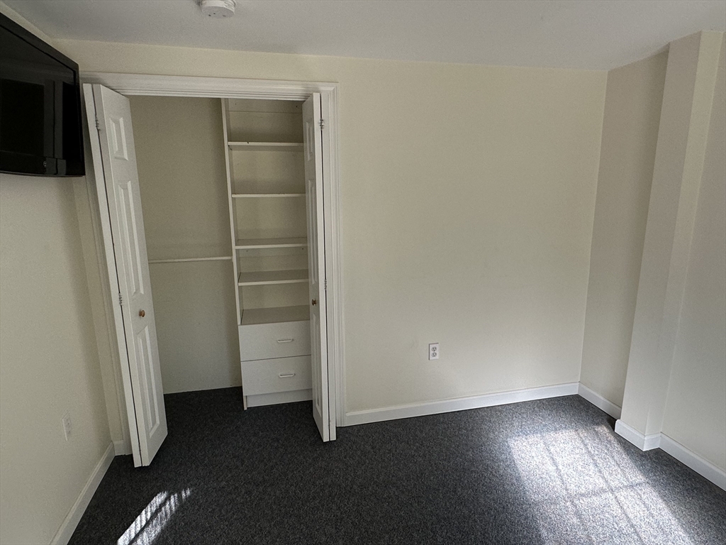 4 Highland Avenue Harvard, MA 01451 - Photo 15 of 29 an empty room with wooden floor and closet
