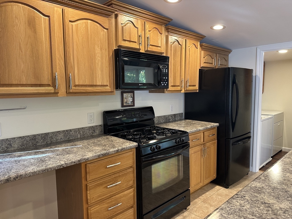 4 Highland Avenue Harvard, MA 01451 - Photo 10 of 29 a kitchen with stainless steel appliances granite countertop a refrigerator stove and sink