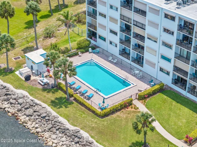 a view of a hallway with wooden floor and entryway