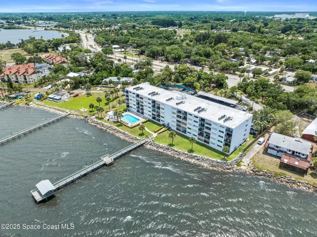an aerial view of a house with a yard