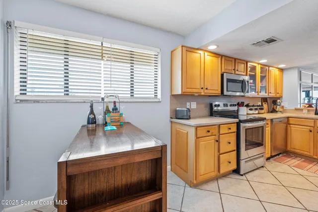 a kitchen with stainless steel appliances granite countertop a sink and cabinets