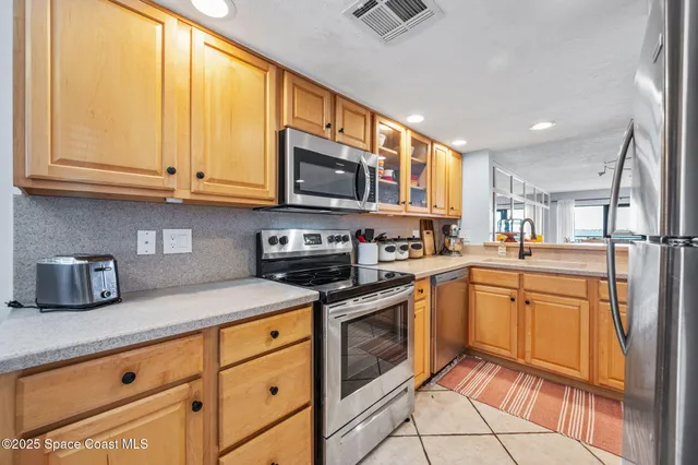 a kitchen with stainless steel appliances granite countertop a sink and cabinets