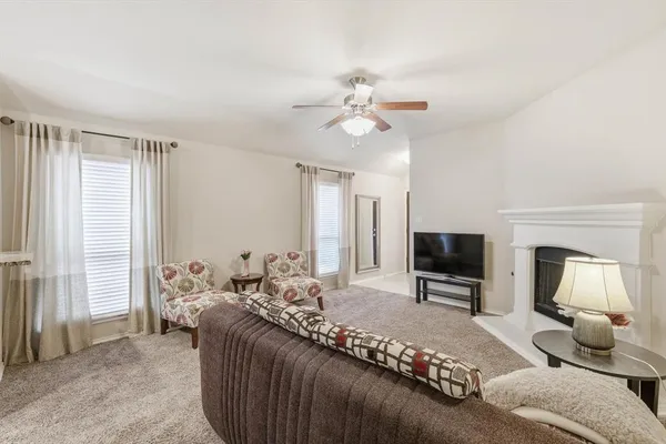 a bedroom with a bed couch and a window