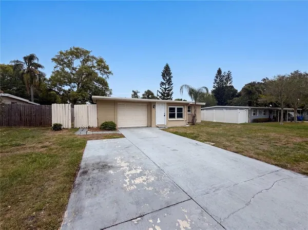 a view of a yard with a house in the background