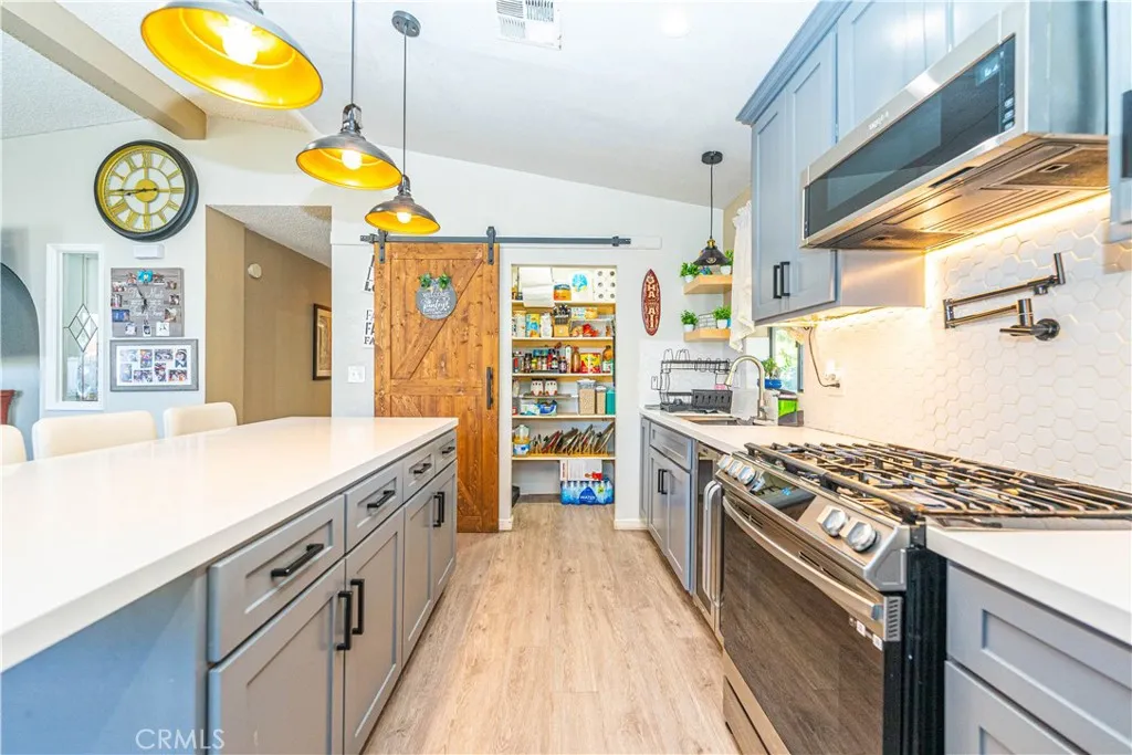 9080 Bloomfield Avenue, Unit 191 Cypress, CA 90630 - Photo 3 of 22 a kitchen with stainless steel appliances granite countertop a stove and a large window
