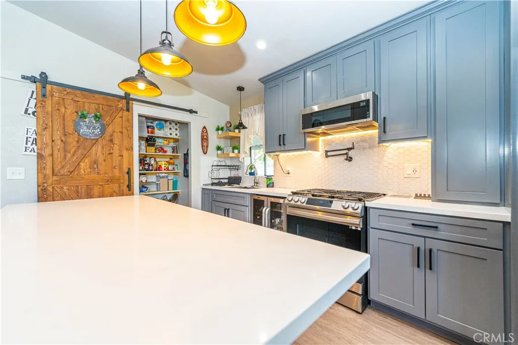 9080 Bloomfield Avenue, Unit 191 Cypress, CA 90630 - Photo 5 of 22 a kitchen with stainless steel appliances a stove a sink and a microwave