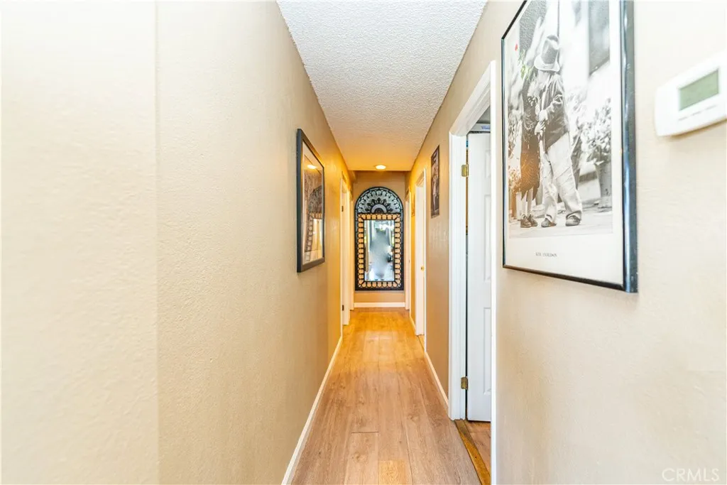 9080 Bloomfield Avenue, Unit 191 Cypress, CA 90630 - Photo 7 of 22 a view of a hallway with wooden floor and dining room